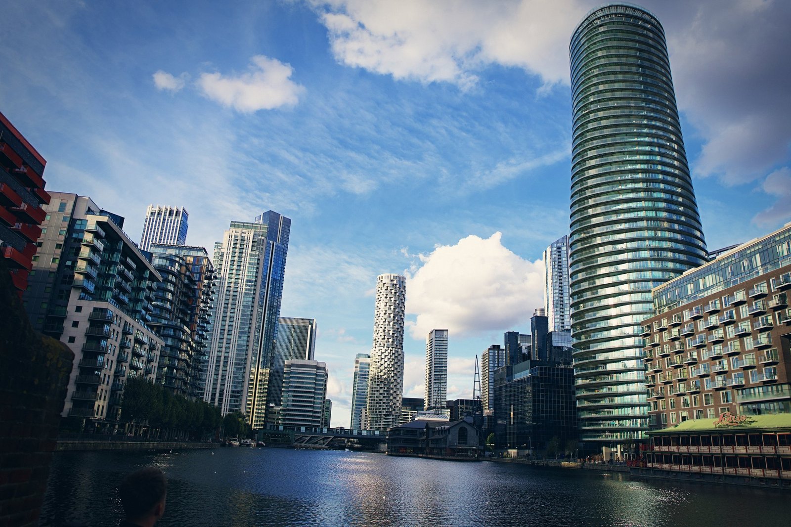 Towers of Canary Wharf reflected in the dock, the curved tower at right